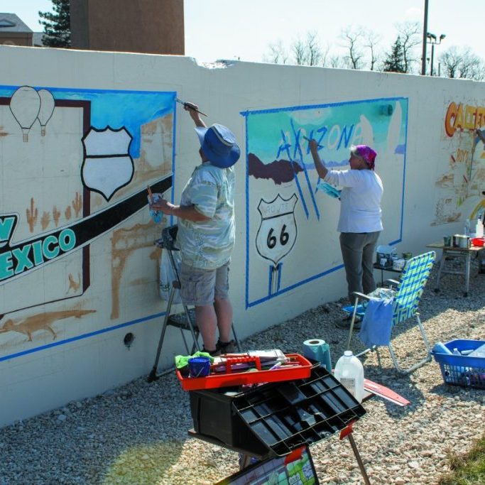 Photo by Shari Harris Patty Burmeister, center, is one of seven artists involved in painting a Route 66 mural in Rolla.